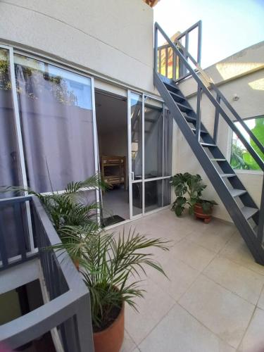 a balcony of a building with a staircase and plants at Casa Bacoba in Santa Marta