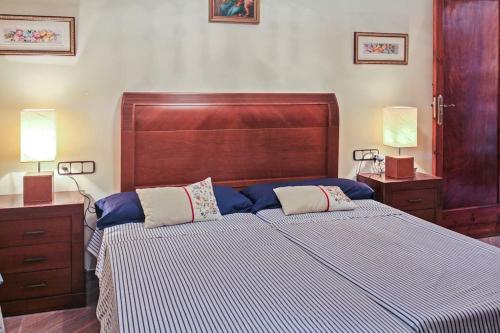 a bedroom with a large bed with blue and white sheets at Huerto Valenciano - Sol y Tranquilidad - Piscina in Valencia
