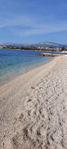 a sandy beach with the ocean in the background at Apartment Blue Eyes in Podstrana