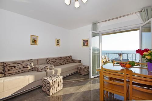 a living room with a couch and a table at Apartment Blue Eyes in Podstrana