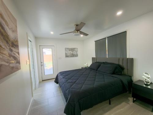 een slaapkamer met een bed en een plafondventilator bij Cozy modern house - Near SXSW and other events in Austin