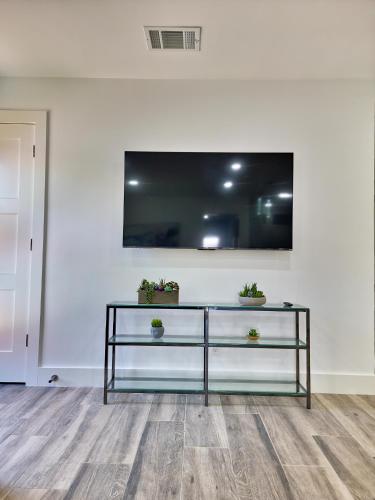 a living room with a tv on a white wall at Cozy modern house - Near SXSW and other events in Austin