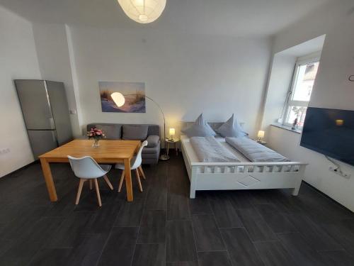 a living room with a bed and a dining room table at Apartments im Mardefeldpalais in Ansbach