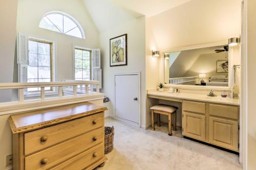 a bathroom with a sink and a large mirror at Cozy Norwich Villa on Golf Course Near Spa! in Norwich