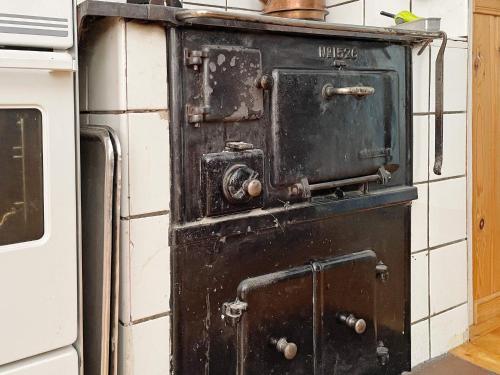 an old black stove sitting in a kitchen at 6 person holiday home in TÖCKSFORS-By Traum in Töcksfors