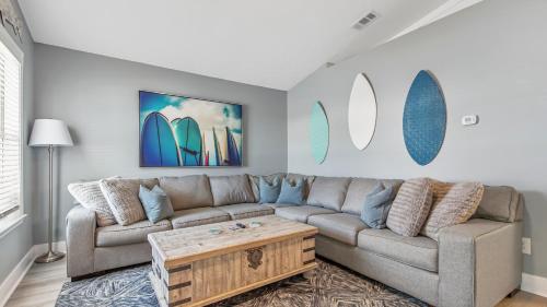 a living room with a couch and a coffee table at Blue Neptune at 5313 Sunset Avenue by Nautical Properties Vacation Rentals in Panama City Beach