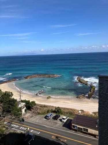 a view of a beach with cars parked on it at Izu Shirahama Taiyo Mansion - Vacation STAY 04444v in Shimoda