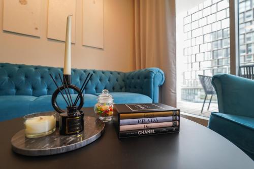 a table with a candle and books on it at The View 1 in Vienna