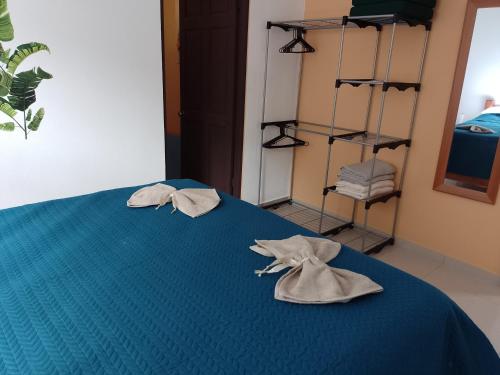 due asciugamani su un letto blu in una stanza di Butterfly a Tajo Alto