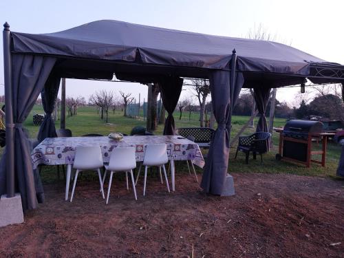 a tent with a table and chairs in a field at Stunning 3-Bed House in San Zenone degli Ezzelini in San Zenone