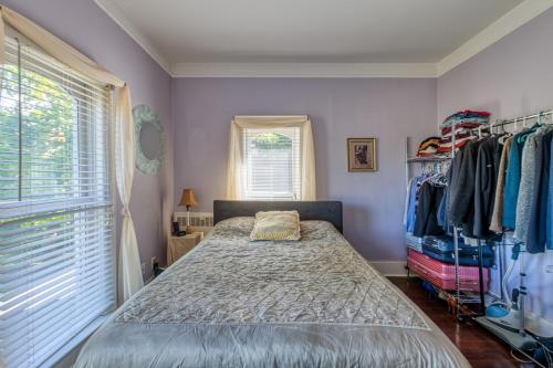 a bedroom with a bed and a closet at Monroe Manor Inn in South Haven