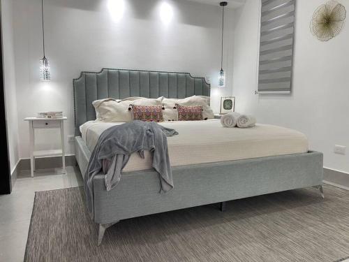 a bedroom with a large bed in a room at Paradise Room Rialto Residences in Santiago de los Caballeros