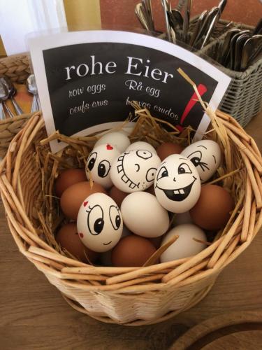 a basket of eggs with faces painted on them at Hotel Cafe Restaurant Loreleyblick in Sankt Goar