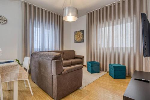 a living room with a couch and a table at Spacious House in Porto for family and friends in Maia