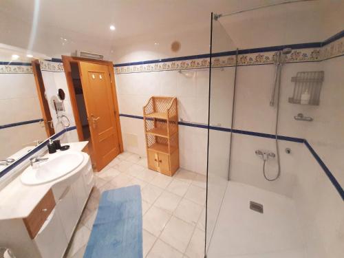a bathroom with a shower and a sink at Cascais - Localização AC Parking Lift in Cascais