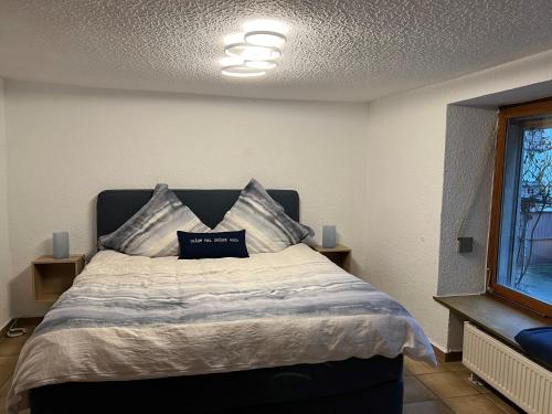 a bedroom with a large bed with two pillows on it at UferZeit - Dein Ankerplatz an der Mosel in Ediger-Eller