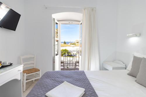 una camera da letto con un letto e vista su un balcone di Achilleas Pension a Hydra