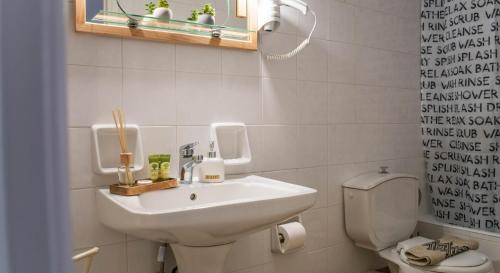 a bathroom with a sink and a toilet at 4keys House 4 in Tripolis