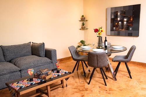 a living room with a couch and a table at Porto Playa Condo Hotel and Beach Club in Playa del Carmen