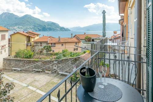 a balcony with a table and a view of the water at CASTLE&LAKE in Rezzonico