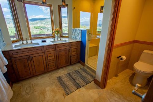 a bathroom with a sink and a shower and a toilet at Vista Grande 1 Mi To Salida 3 Or 4 Bdrm Options in Salida
