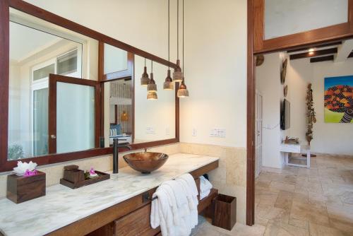 a bathroom with a sink and a mirror at The Lodge at Jaguar Reef in Hopkins