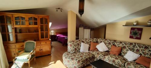 a living room with a couch and a bedroom at Casa Carmen in Faraján