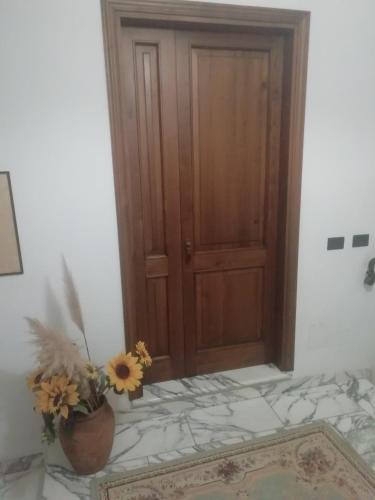 a room with a door and a vase with flowers at Casa Giovanna in Venturina Terme