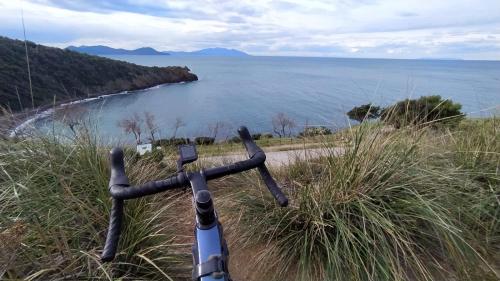 a bike parked on a hill near a body of water at Casa Giovanna in Venturina Terme