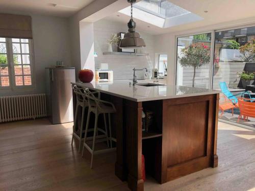 a kitchen with a large island with a counter top at Villa Le Nid in Deauville