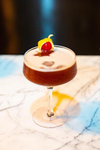 a chocolate cocktail with a cherry on a table at SLS Hotel, a Luxury Collection Hotel, Beverly Hills in Los Angeles
