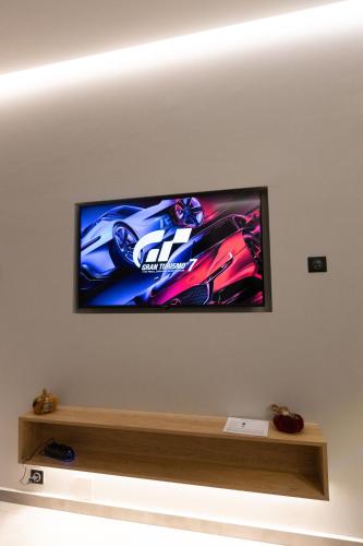 a flat screen tv hanging on a wall at BillMar Luxury Apartment in the center of Gythio in Gythio