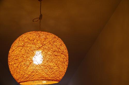 a yellow light hanging from a ceiling at Wafu Ryokan Uehonmachi in Osaka