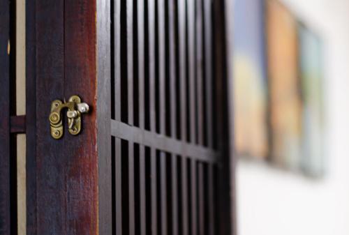 a close up of a wooden door with a latch at Wafu Ryokan Uehonmachi in Osaka