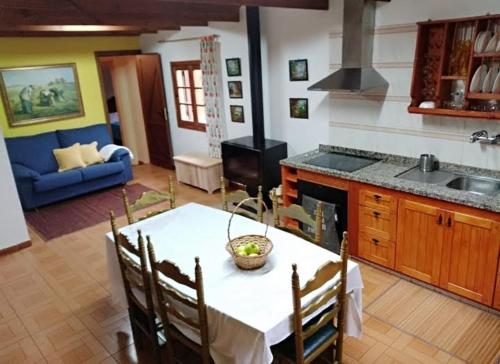 a kitchen with a table and a couch in a room at Floral garden house in Icod de los Vinos