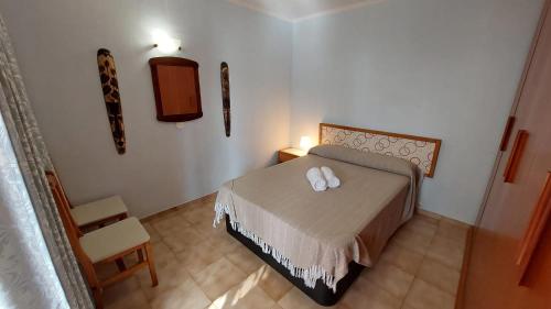 a bedroom with a bed with two white towels on it at SIMPLE Apartment Frontera Primavera POOL in South TENERIFE in Costa Del Silencio