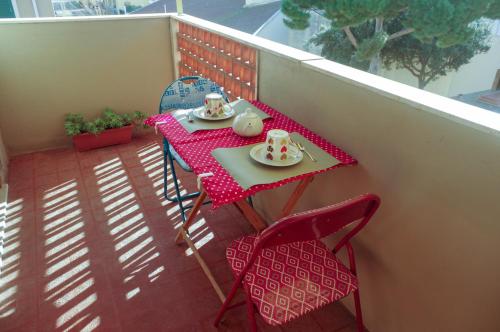 a table and chairs on a balcony with a tea set at Casa della Nonna in Piombino