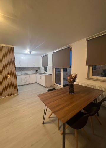 a large kitchen with a wooden table in a room at Apartment Brussels Airport and NATO OTAN headquarters in Machelen