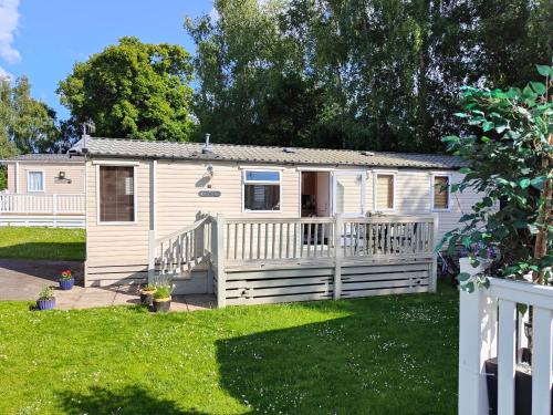a tiny house in a yard with a fence at Holiday home sleeps six in Poole