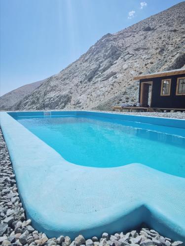 a swimming pool in front of a house at Cabaña Alma de Montaña, piscina privada in Monte Grande