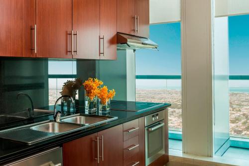 a kitchen with a sink and a large window at Four Points by Sheraton Sheikh Zayed Road in Dubai