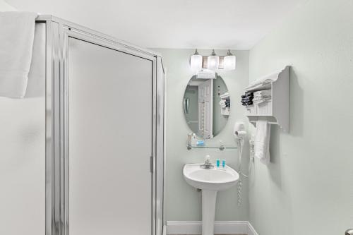 a white bathroom with a sink and a mirror at Beach Front 16th Flr, Best Ocean View, New Upgrades in Destin