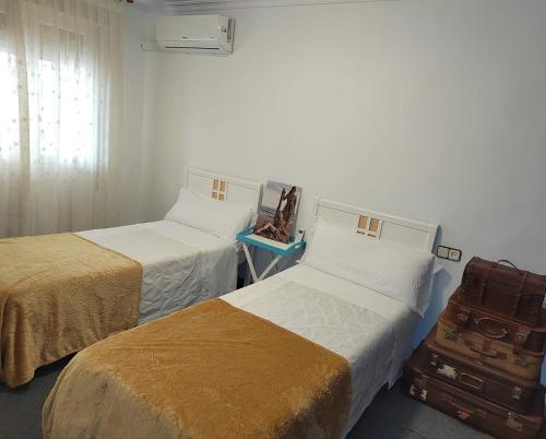 a room with two beds and a window at Apartamento ALBACETE CENTRO con 1 plaza de PARKING GRATIS in Albacete