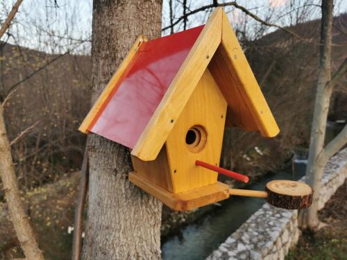 a wooden bird house hanging on a tree at Rest House Ripac in Praščijak