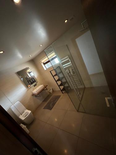 a bathroom with a toilet and a glass door at Hill Top House 