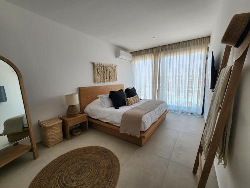 a bedroom with a bed and a large window at Aria Ocean mountain 715B QueridaEstancia in Bucerías