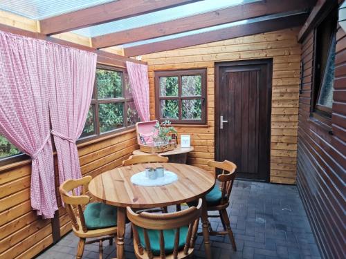 a dining room with a wooden table and chairs at Kranich-Holzferienhaus 'Kleine Auszeit' in Rehden