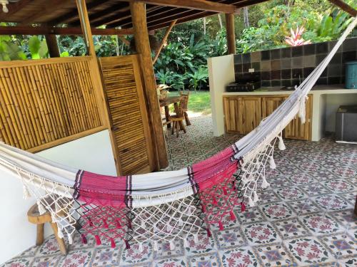 a hammock in the middle of a room with a kitchen at Salvia Madre Hotel Boutique in Guachaca