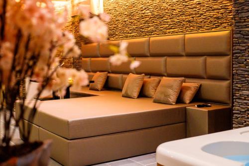 a couch with pillows on it in a bathroom at Privé Spa L'amour in Nuenen