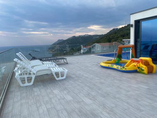 a balcony with play equipment on top of a house at A. Montenegro in Dobra Voda